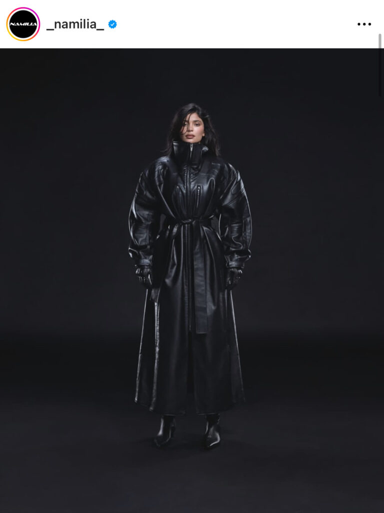 Kylie Jenner trägt einen schwarzen Faux-Leather-Mantel.