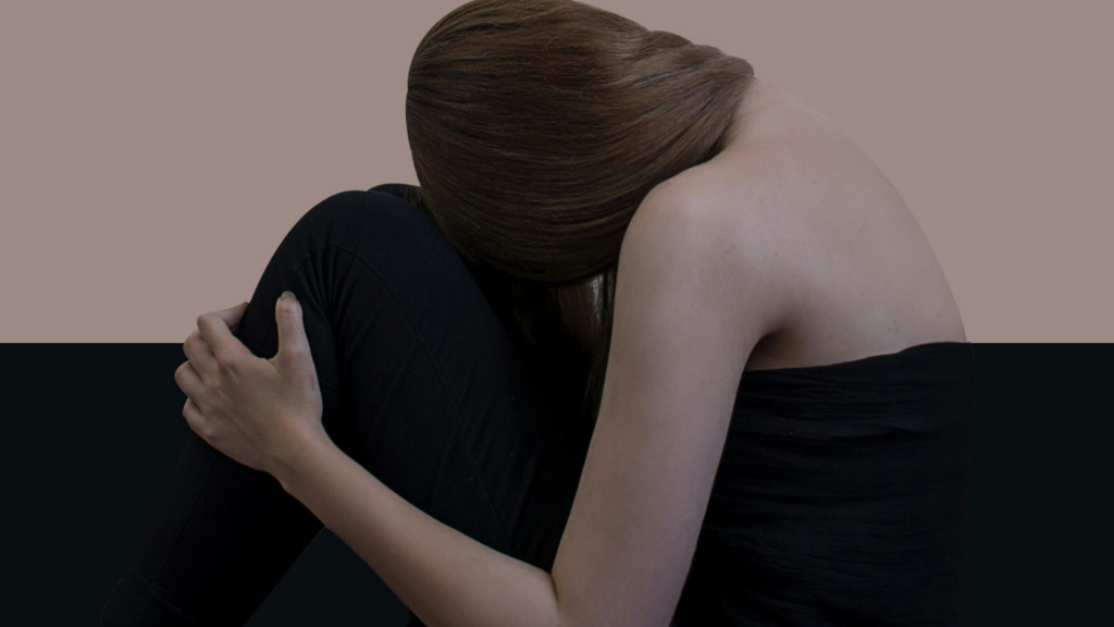 Eine Frau von hinten, sie lehnt sich an ihr Knie